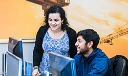 Male and female training at a computer